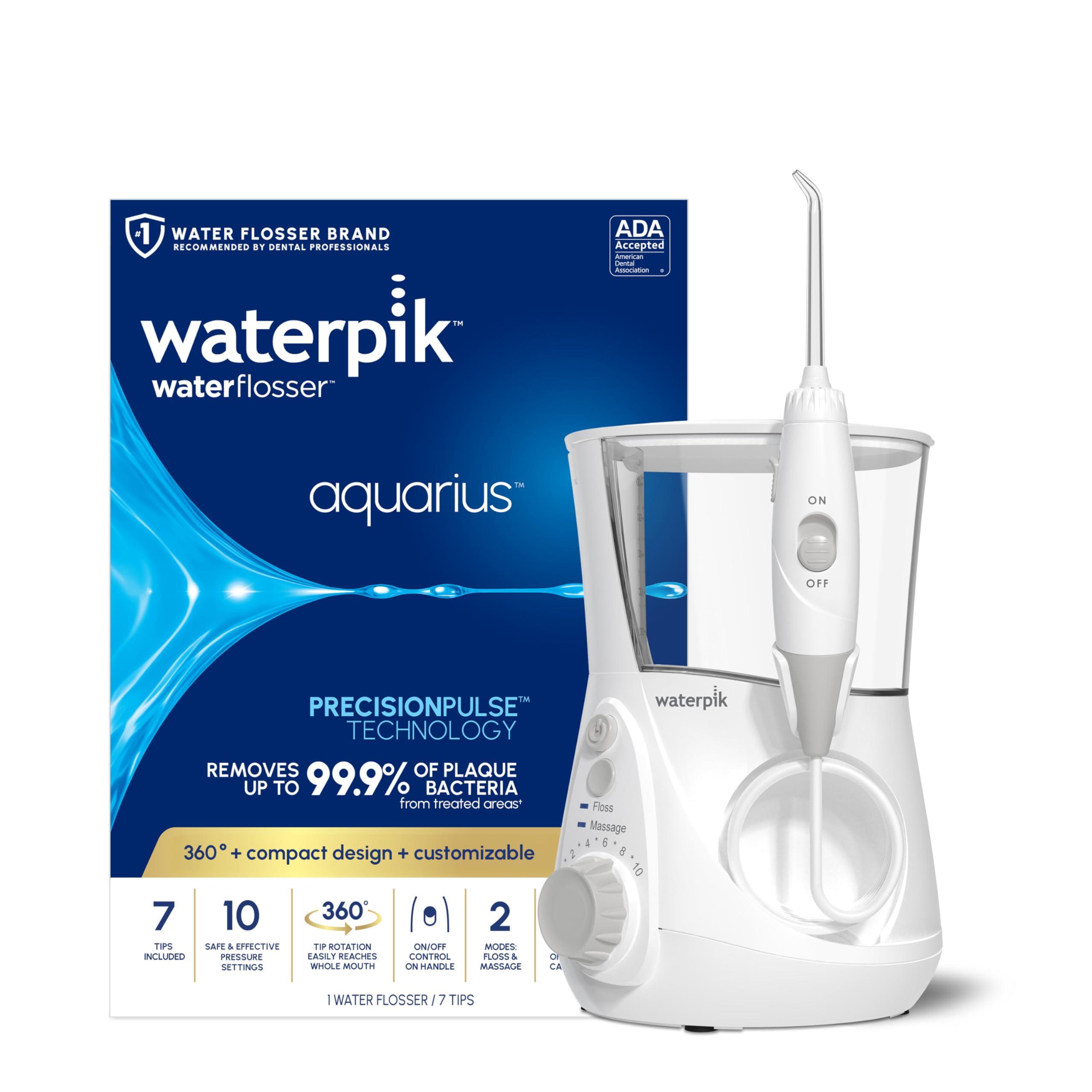 Waterpik Aquarius Water Flosser WP-660 on a bathroom counter with wand and tips