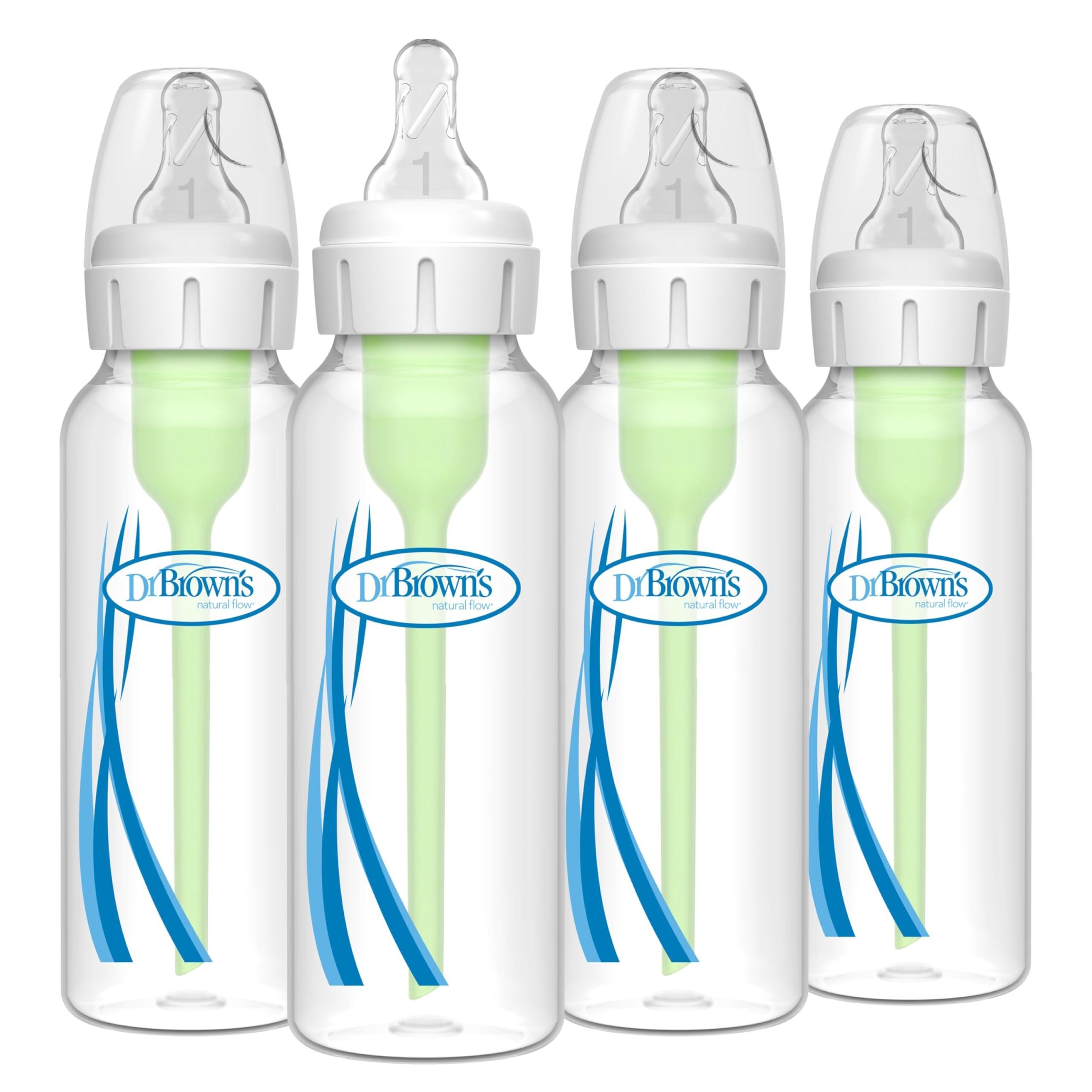 Assorted baby bottles on a soft blanket