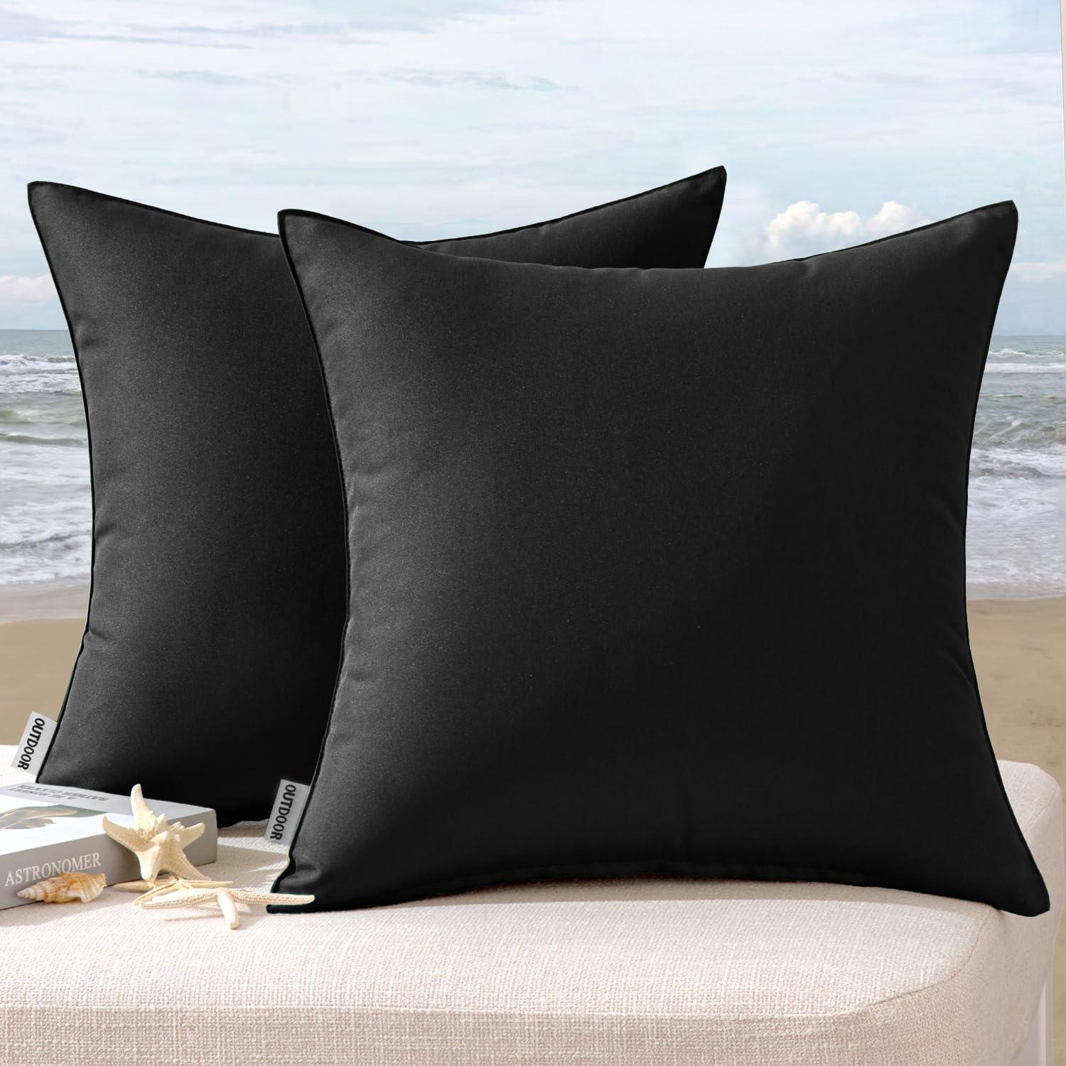 MIULEE Pack of 2 Waterproof Pillow Covers in gray stacked on a bench