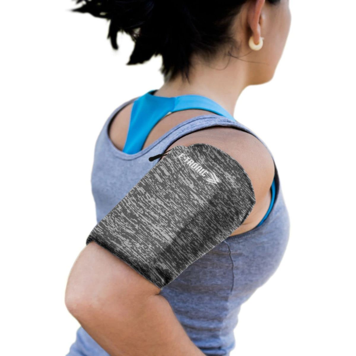 E Tronic Edge armband with reflective logo on a runner's arm during a sunset jog