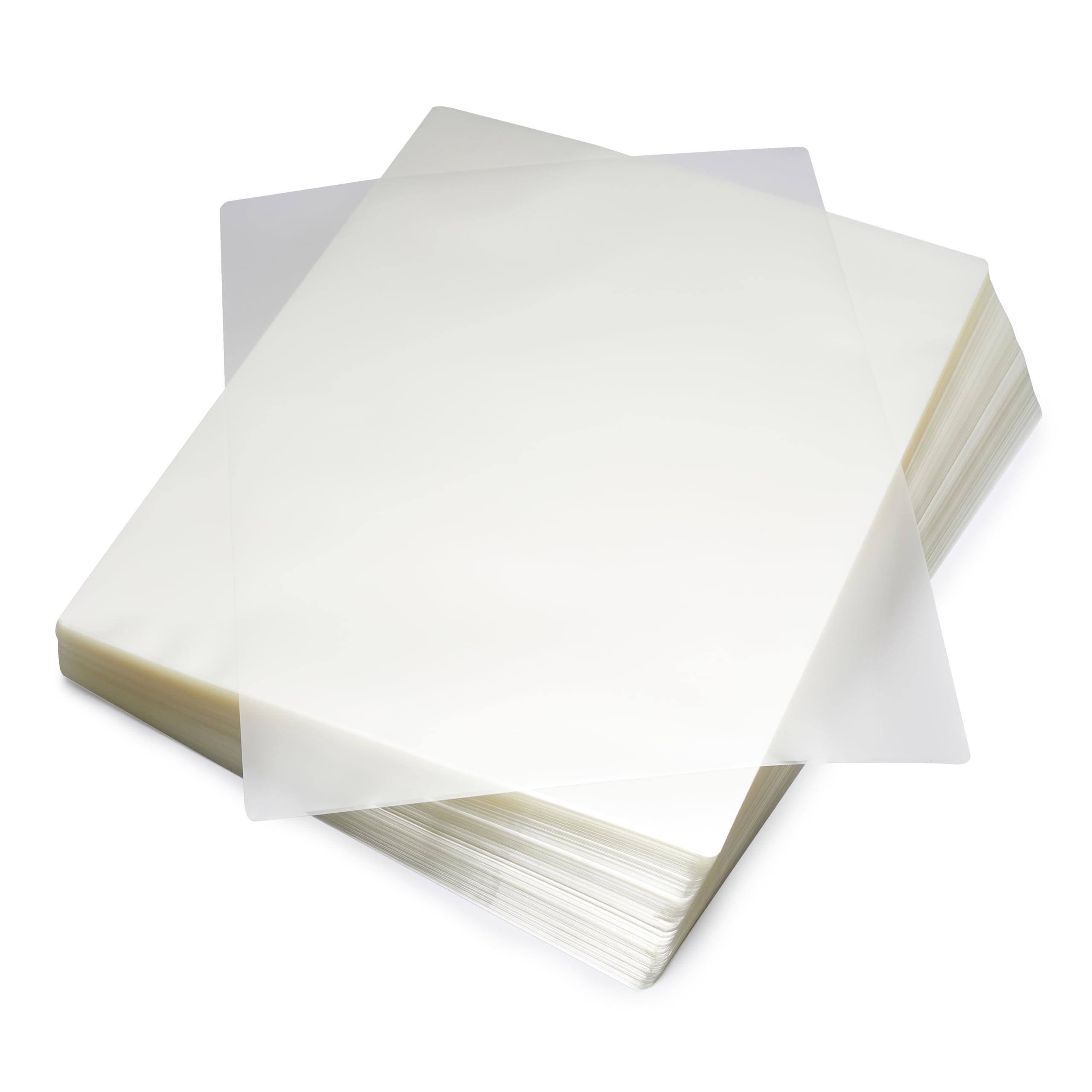 Stack of Amazon Basics Clear Thermal Laminating Sheets on a desk
