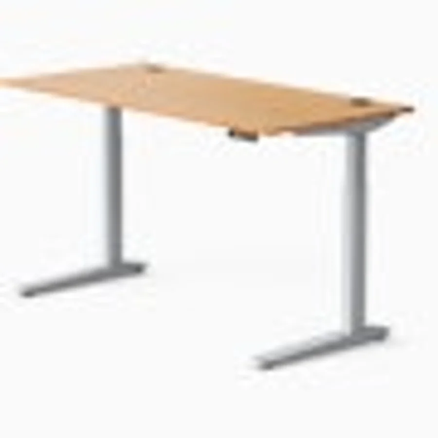 Fully Jarvis Bamboo standing desk featuring a 60x27 inch dark bamboo desktop with visible bamboo grain pattern, mounted on the silver T-shaped Jarvis electric frame with the memory preset controller integrated under the front desktop edge — the design-conscious premium pick for video-call-visible home offices