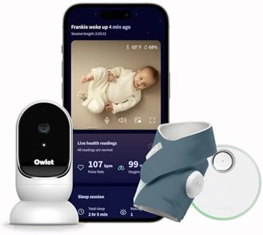 Owlet Dream Duo system showing all three components: the white-and-black Owlet Cam 2 monitor, a smartphone displaying the Owlet app interface with baby-monitoring data overlay, and the FDA-cleared Owlet Dream Sock — the only consumer baby monitor on the 2026 US market with FDA 510(k) medical-device clearance