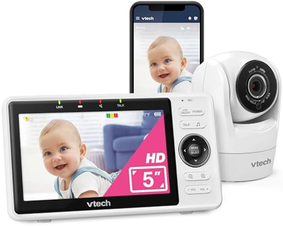 VTech VM901 Smart WiFi Baby Monitor system showing the dedicated 5-inch HD parent monitor displaying a baby, a smartphone displaying the same feed via the MyVTech Baby app, and the white tabletop VTech-branded camera unit — the smartest sub-US$150 baby monitor on the 2026 US market with both Wi-Fi and dedicated screen
